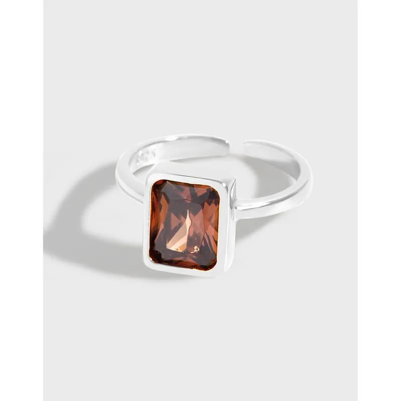 Sterling silver ring with a rectangular brownish-red gemstone in a bezel setting.