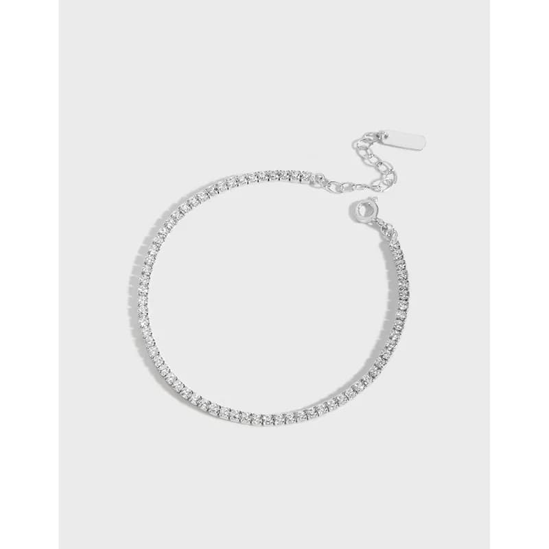 Polished sterling silver pavé bracelet with an extender chain and clasp on a white background.