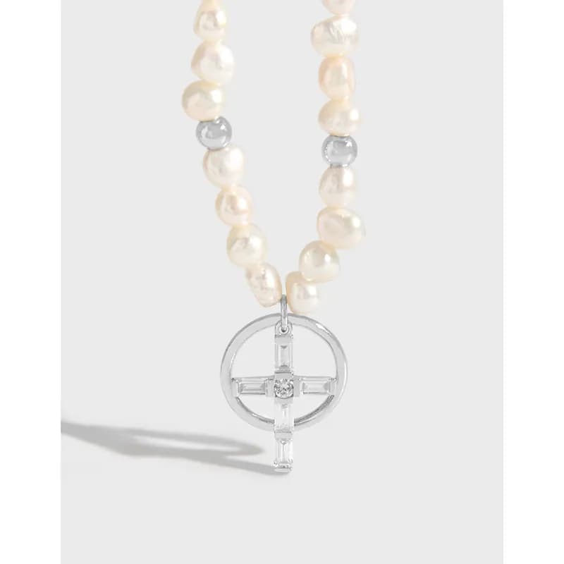 Polished sterling silver pearl necklace with a circular cross pendant and crystal center