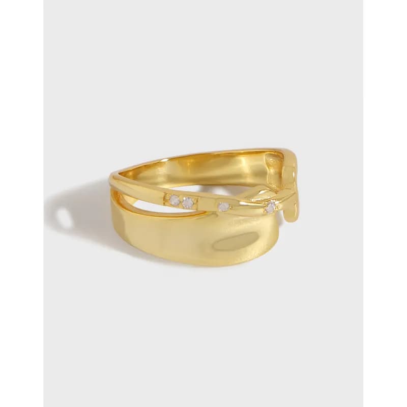 Polished sterling silver intertwined two-band ring with small stones along the upper band.