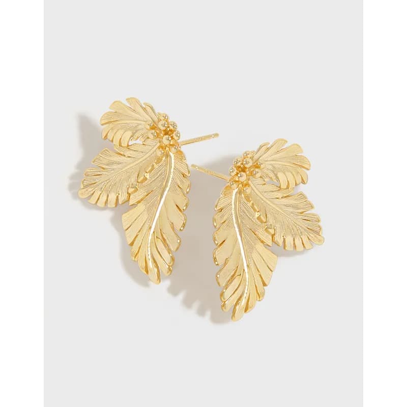 Polished gold-tone leaf-shaped earrings with textured veins and stud backs