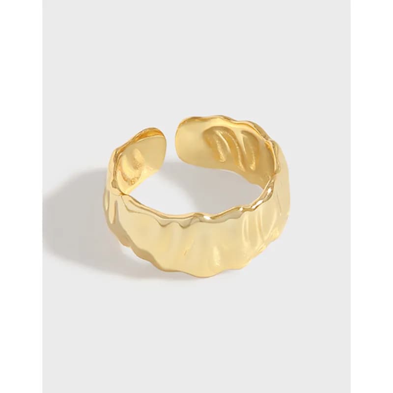 Open, wavy textured ring with a polished surface, seen in a gold-tone hue.