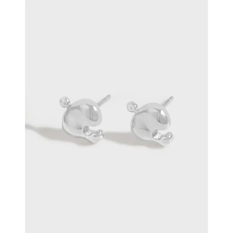 Polished sterling silver abstract circle stud earrings on a pale background.