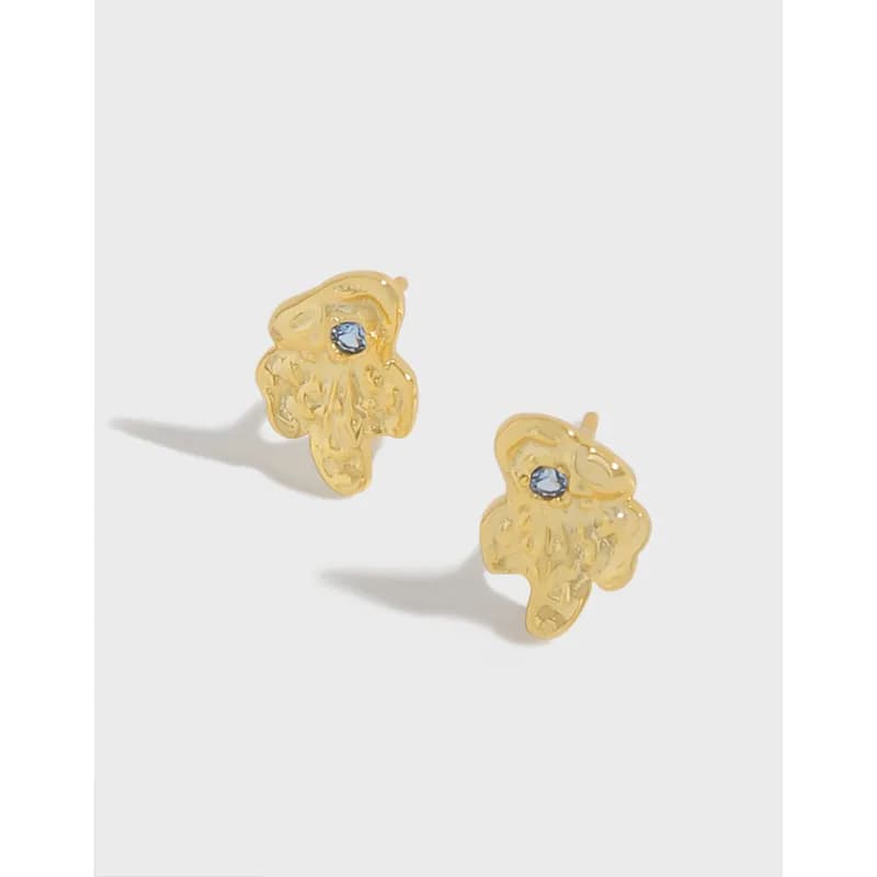 Polished sterling silver four-petal flower stud earrings with a small blue center stone