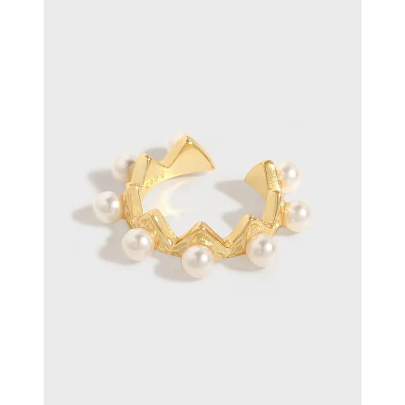 Polished sterling silver pearl-embellished zigzag ear cuff displayed on a white background.