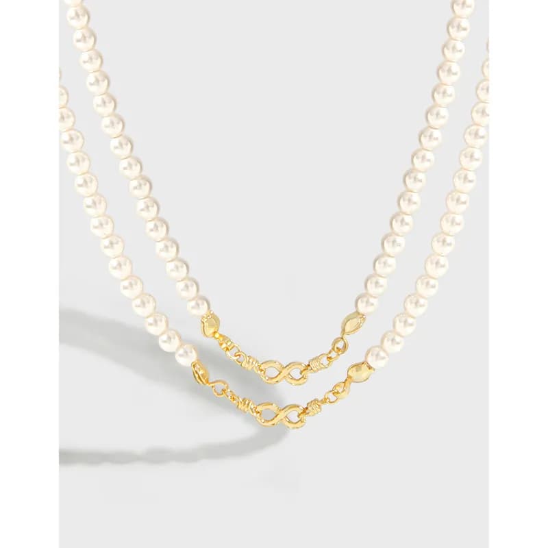 Two-layer pearl bead necklace with a gold-tone chain detail at the front.