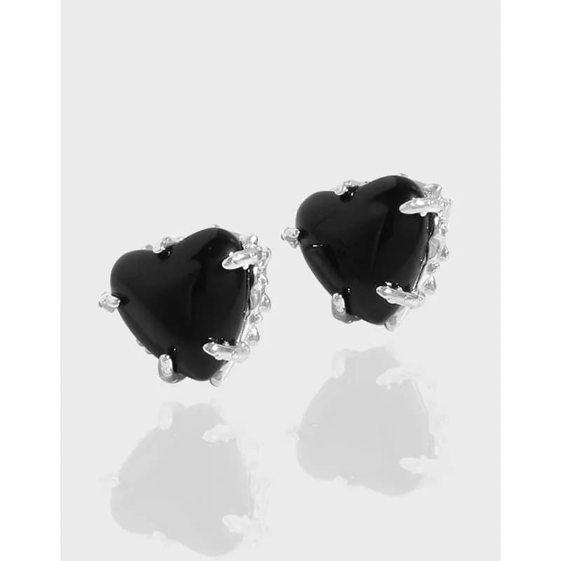 Pair of black heart-shaped stud earrings in polished sterling silver.