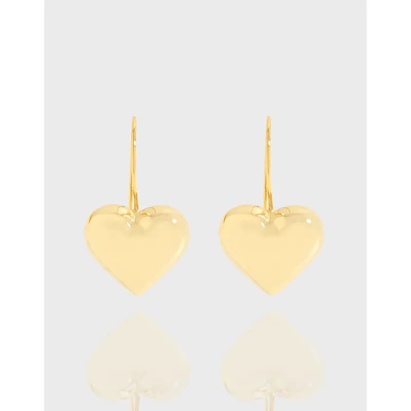 Polished sterling silver heart drop earrings with slender hooks and reflective hearts on a light background.
