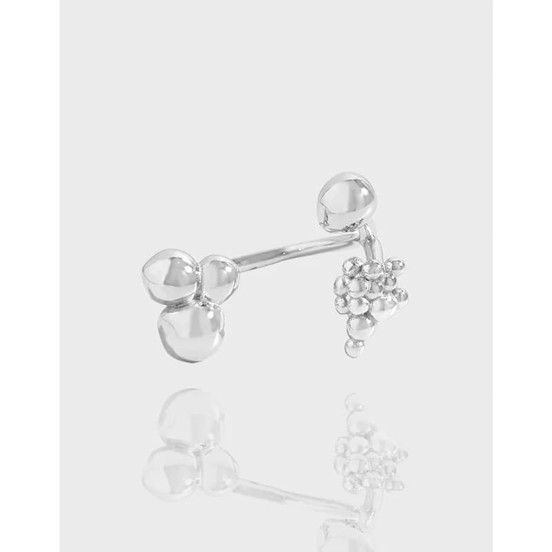 Polished sterling silver open ring with bubble cluster and single orb ends on a pale background.