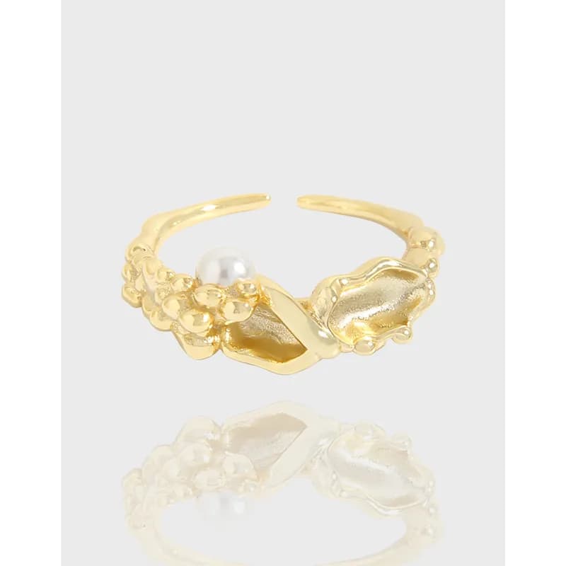 Gold-tone ring with bubble cluster motifs and a pearl accent on an open band
