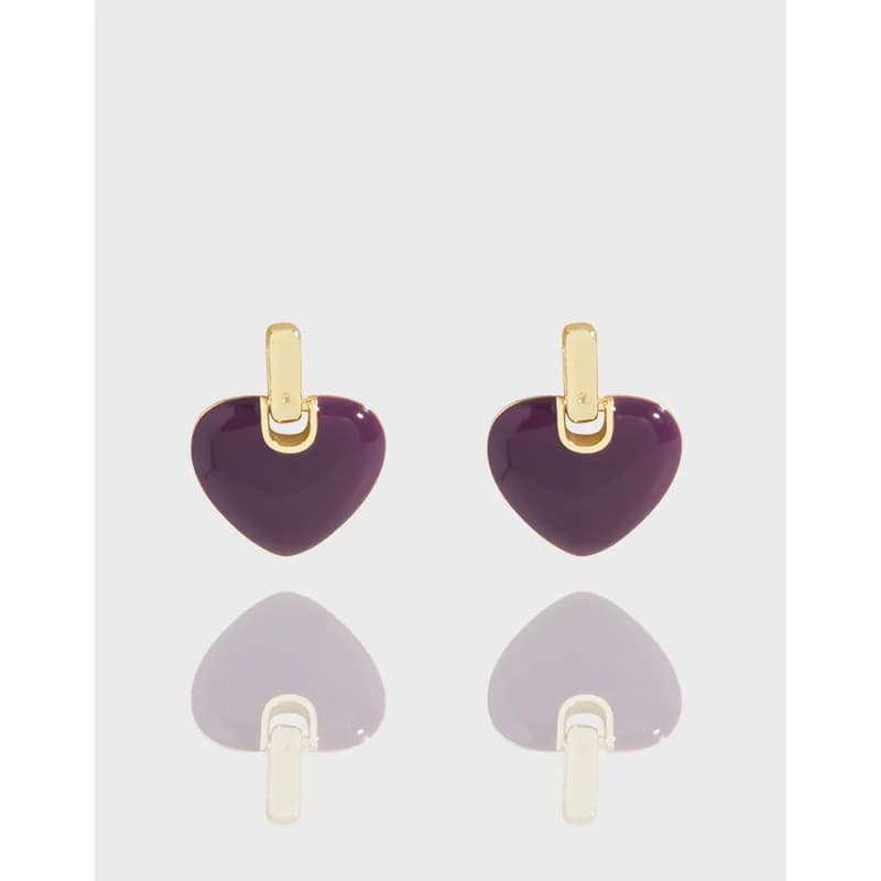 Pair of purple enamel heart earrings with gold-tone bails on a light background.