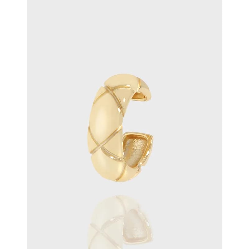 Polished sterling silver crisscross hoop earring shown in close-up on a light background.