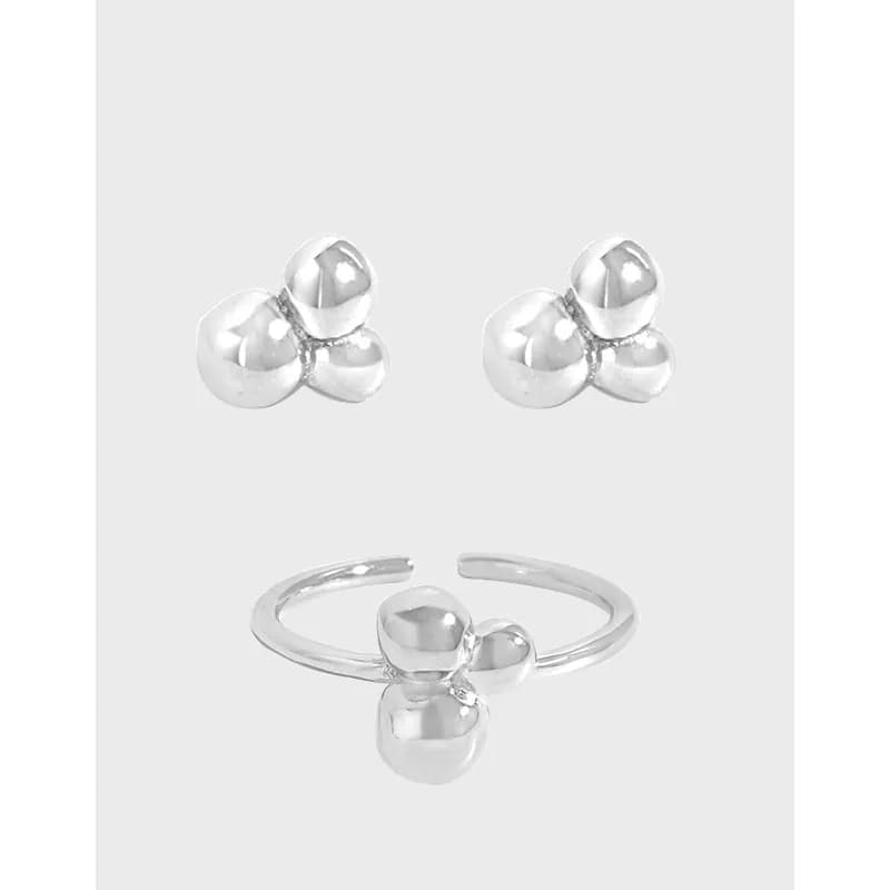 Polished sterling silver ring with a three-ball cluster centerpiece on a slim open band.