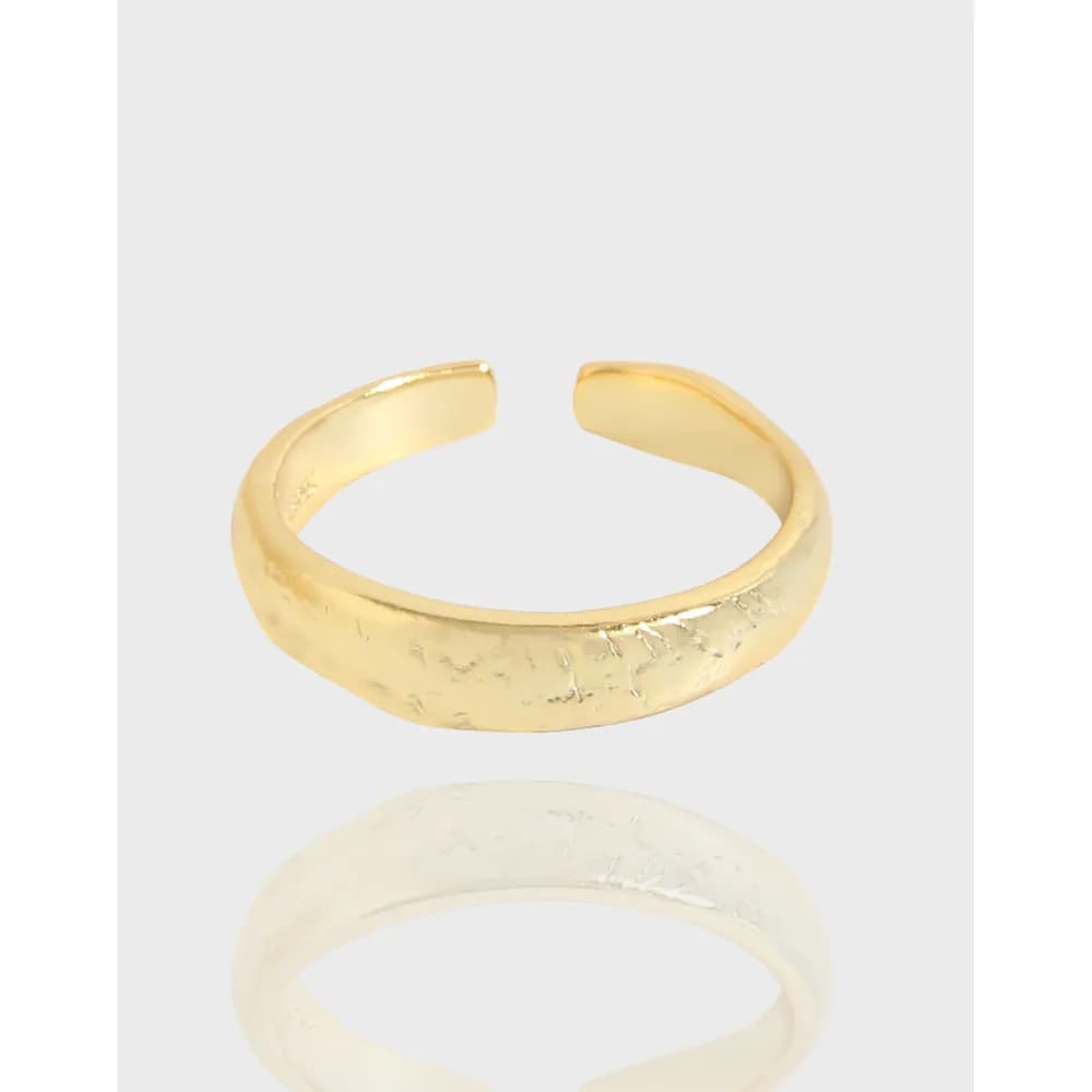 Open-ended hammered band ring with a polished finish on a light background.