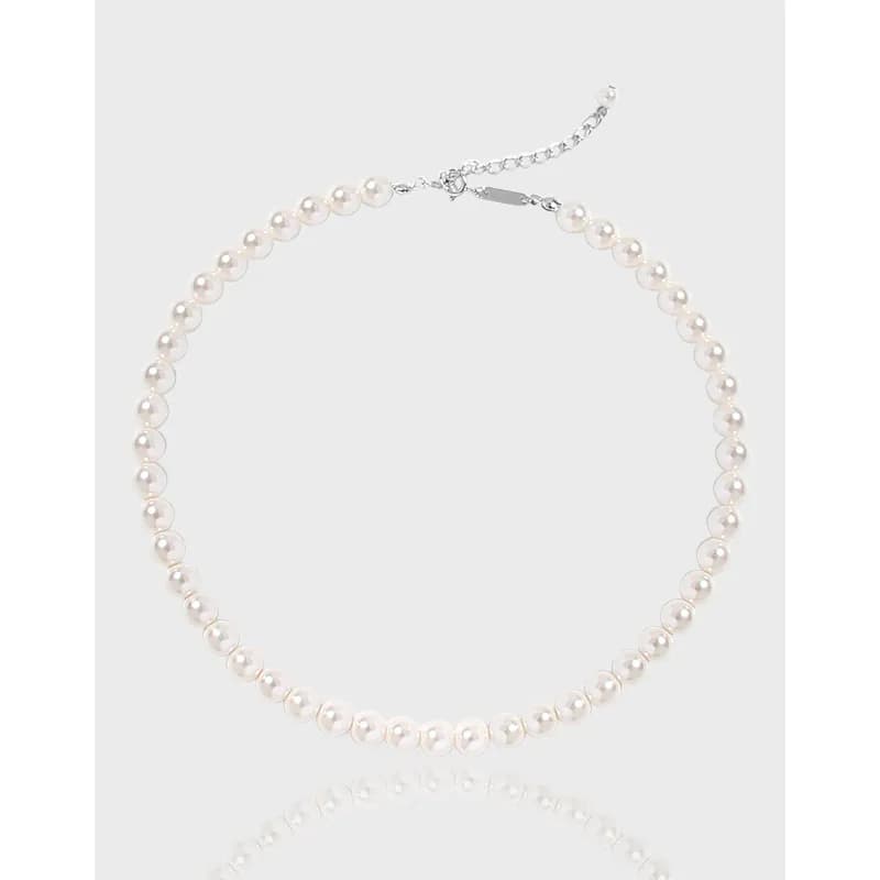 Pearl bead necklace with an adjustable chain and lobster clasp.