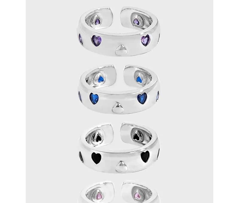 Open-ended sterling silver ring with enamel heart accents around the band in multiple colors.
