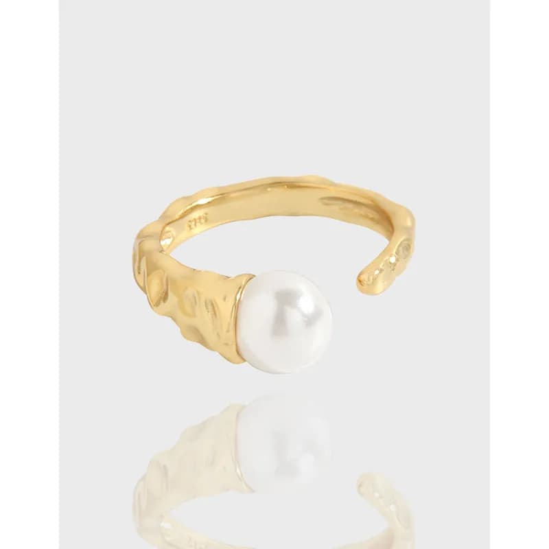 Open pearl ring with a textured, organic band and a single white pearl at the end
