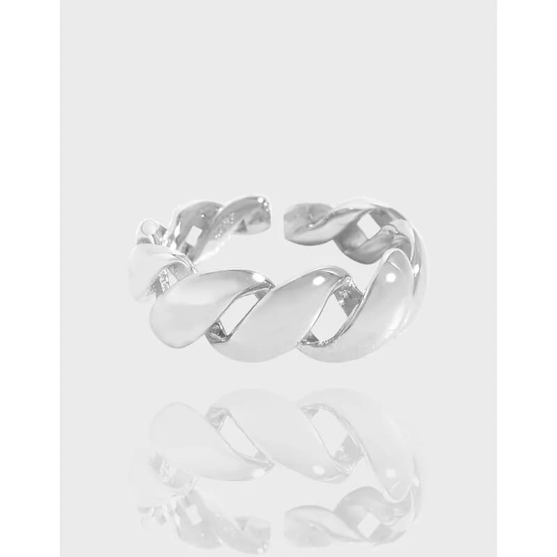 Polished sterling silver ring with twisted leaf-like links on a pale background