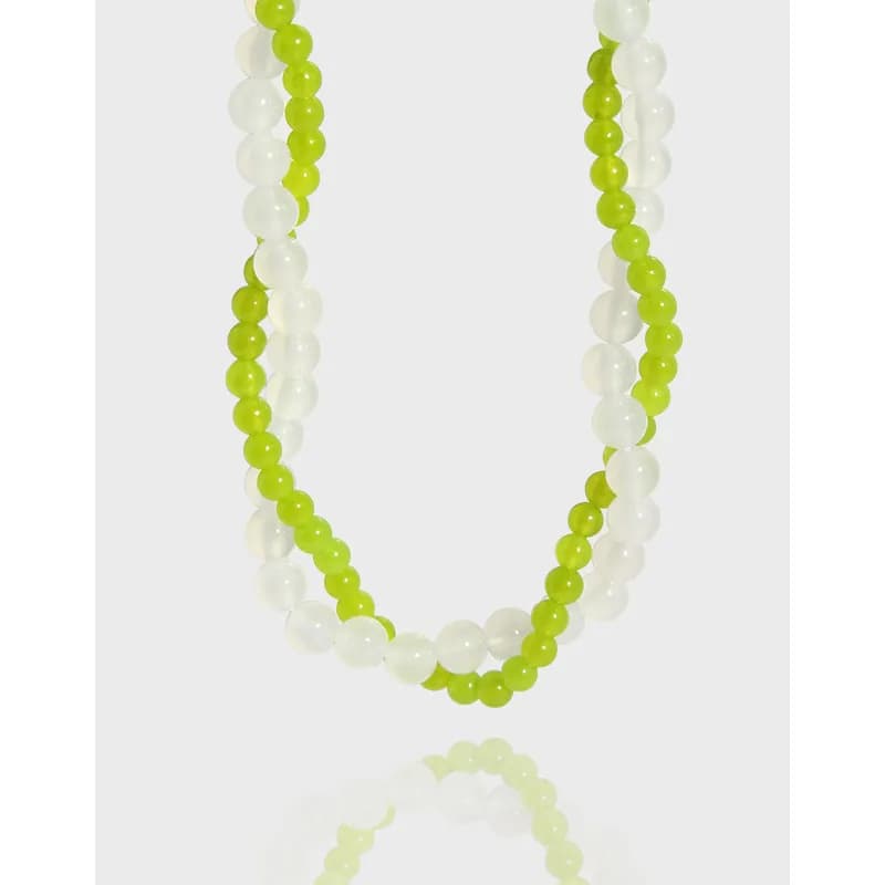 Double-strand lime green and white bead necklace with polished silver finish.