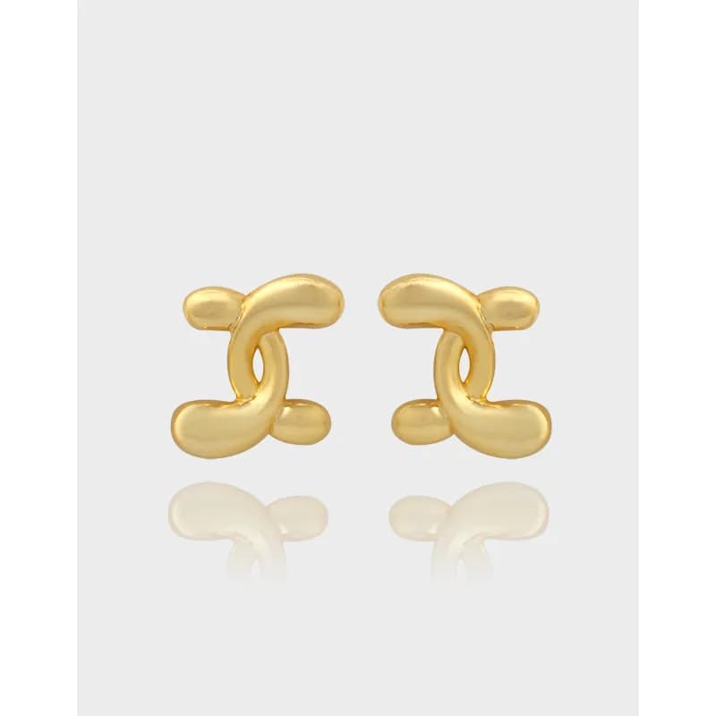 Polished sterling silver interlocking curve stud earrings on a pale background