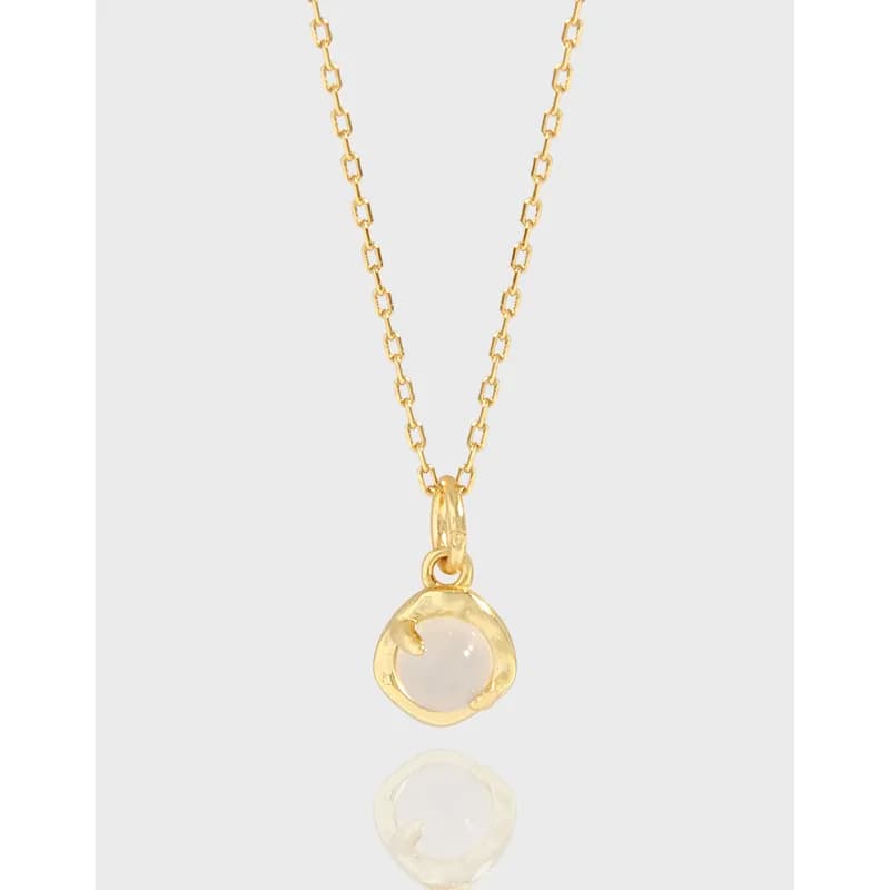 Polished sterling silver necklace with a round milky stone pendant hanging from a delicate chain.