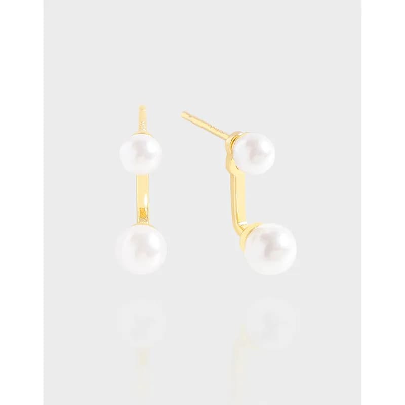 Polished sterling silver earrings with a curved bar and two white pearls, one at the top and one at the bottom.