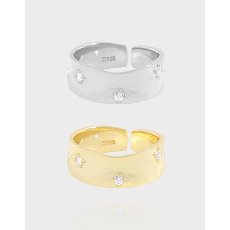 Silver and gold wide band rings with small stones evenly spaced around the outer surface