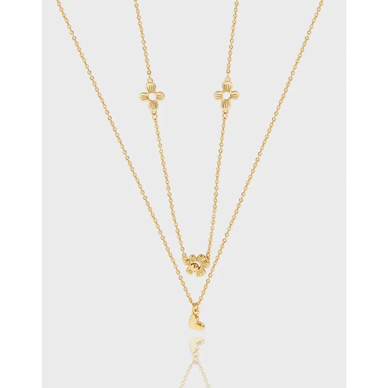 Polished sterling silver layered necklace with multiple flower charms and a tiny heart pendant on the longest chain.