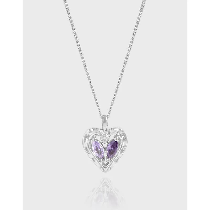 Polished sterling silver heart pendant with purple stones on a fine chain