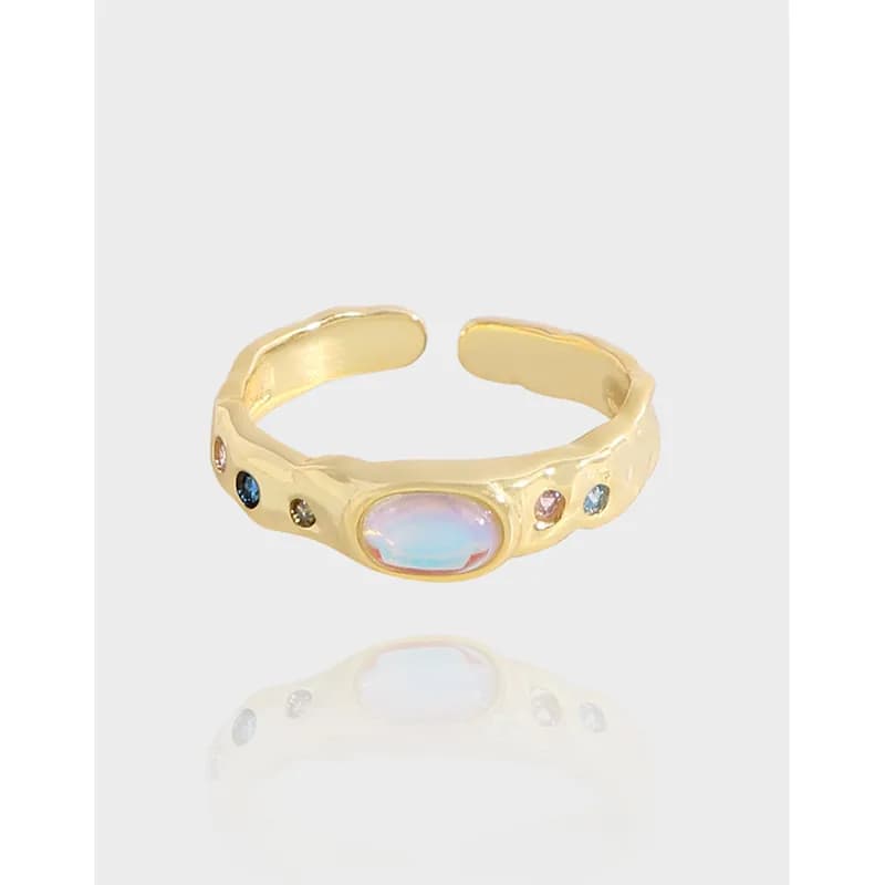 Polished sterling silver ring with an oval opal centerpiece and small colored stones along the band.