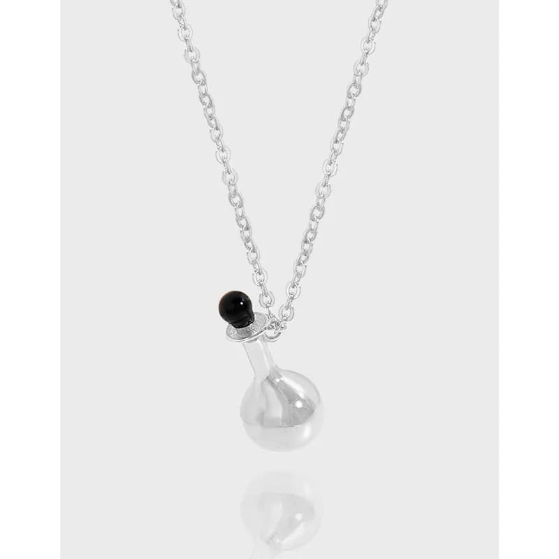 Polished sterling silver chain with a clear glass flask pendant and a small black stopper