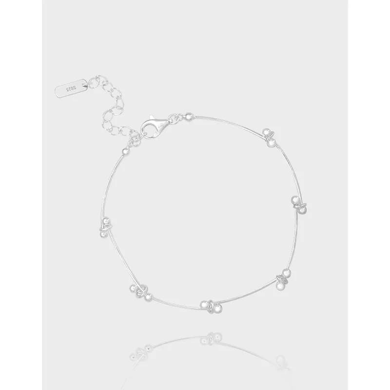 Delicate sterling silver bracelet with small bead clusters along a thin cable chain and a lobster clasp