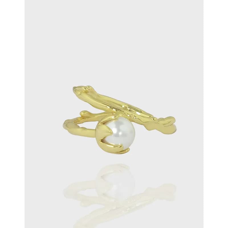 Polished sterling silver ring with a branch design and a white pearl in the center.