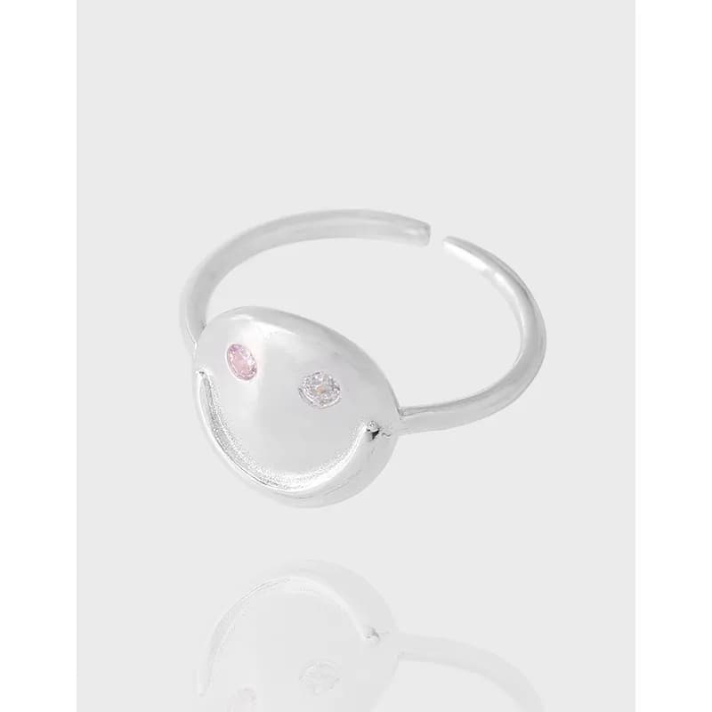 Polished sterling silver open ring with a circular disk face featuring pink and clear gemstone eyes.