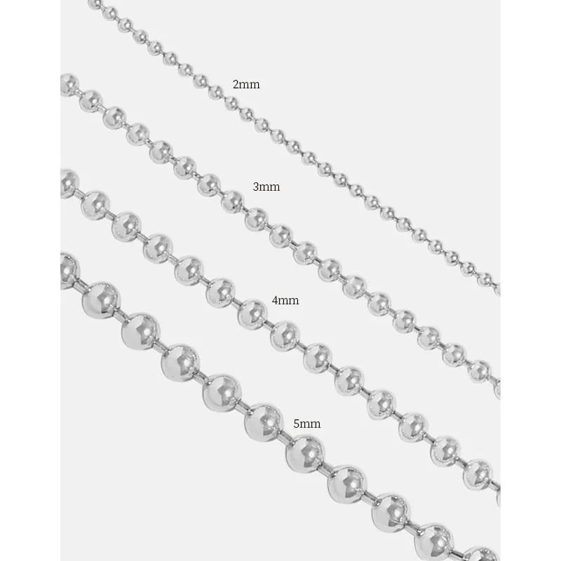 Polished sterling silver beaded ball chain bracelet with varying bead sizes laid diagonally.