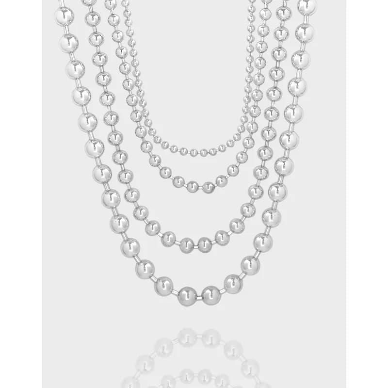Polished sterling silver multistrand necklace with five cascading beaded strands of different sizes.