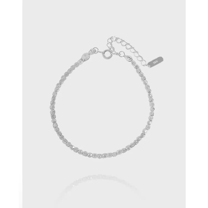 Close-up of a delicate sterling silver faceted bead bracelet with an extender and clasp