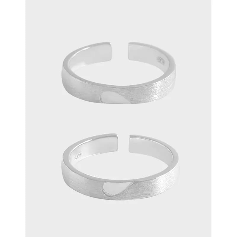 Two sterling silver hammered open cuff rings shown from a slight angle.
