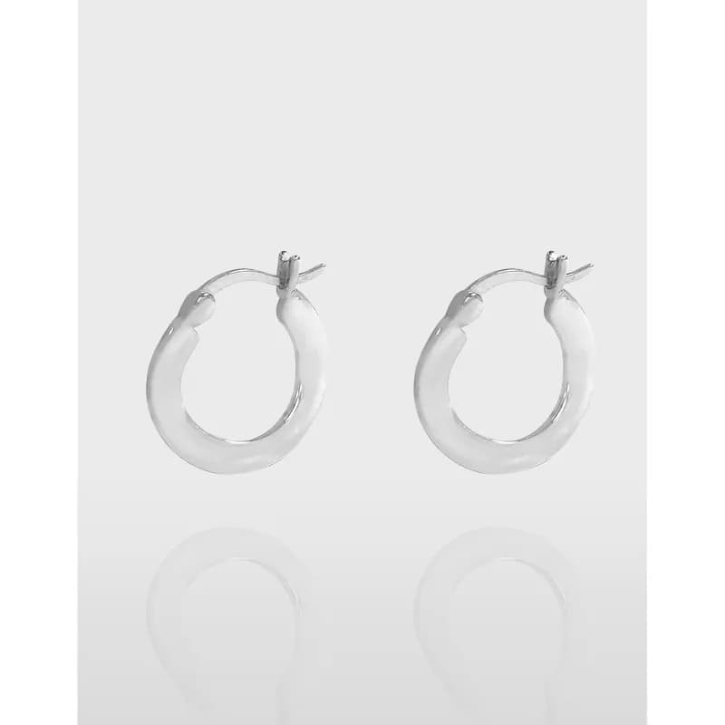 Polished sterling silver hoop earrings with a rounded circular silhouette on a light background.