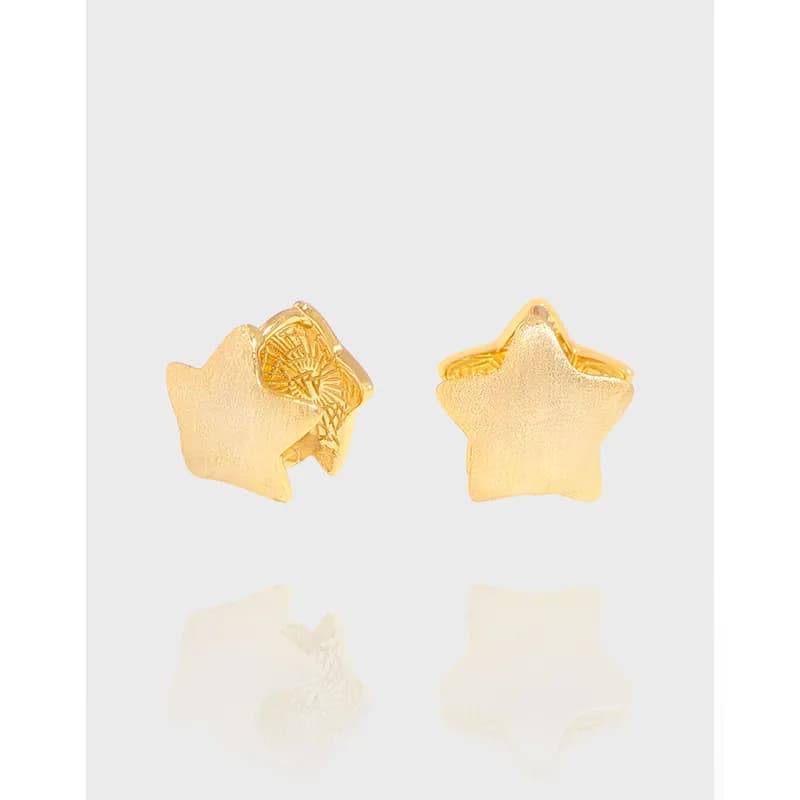 A pair of polished sterling silver star stud earrings viewed from the front and side.