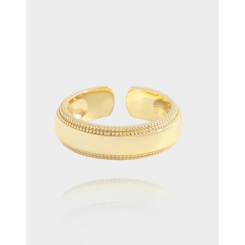 Open-ended sterling silver ring with a wide smooth central band and two beaded border details.
