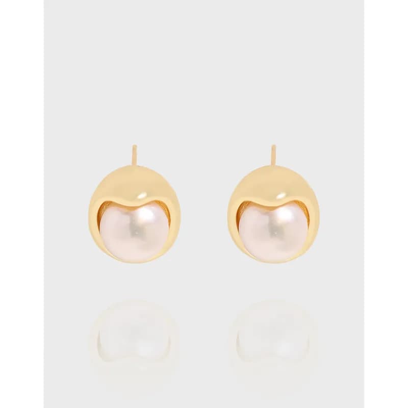 Two polished circular stud earrings with central pale pearls set within a hollow halo.