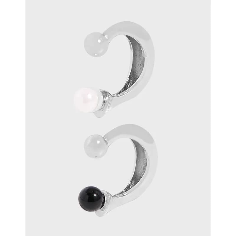 Polished sterling silver crescent earrings with bead-end accents in white and black bead colors.