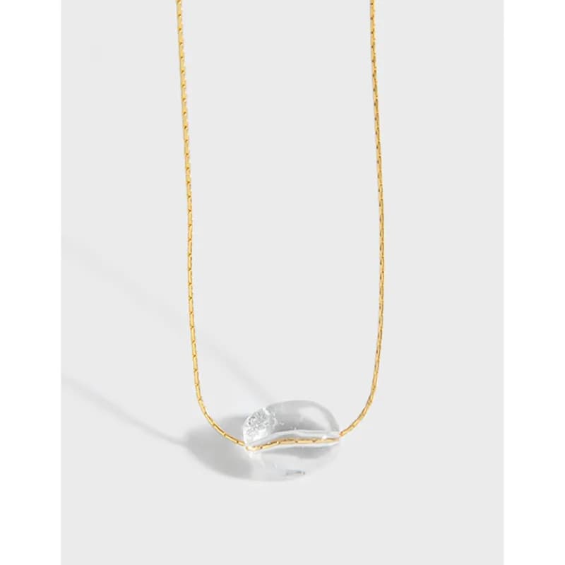 Polished sterling silver chain necklace with a clear glass bead wrapped in a gold-tone accent at the center.