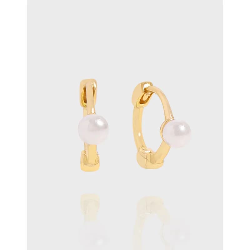 Polished sterling silver hoop earrings each with a single white pearl on the outer curve.