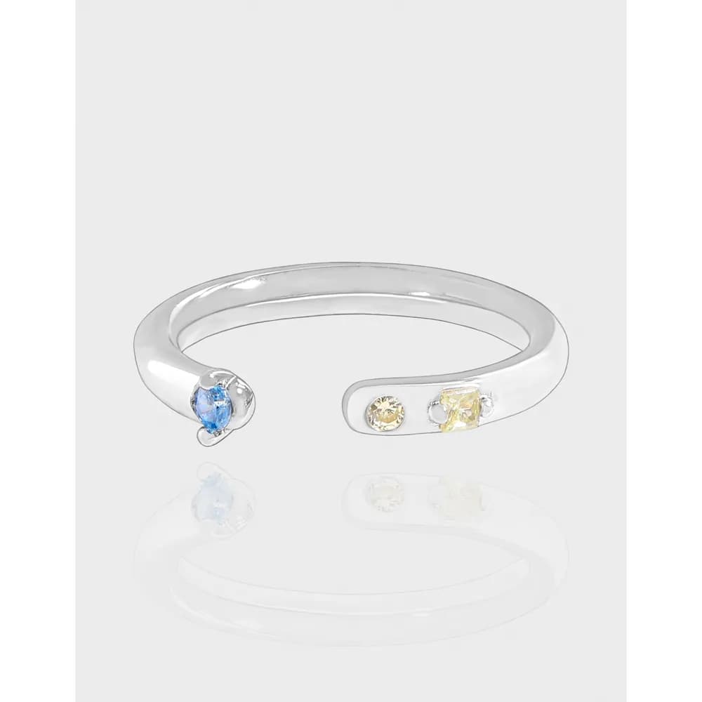 Polished sterling silver open-ended ring with blue stone on one end and yellow stones on the other.