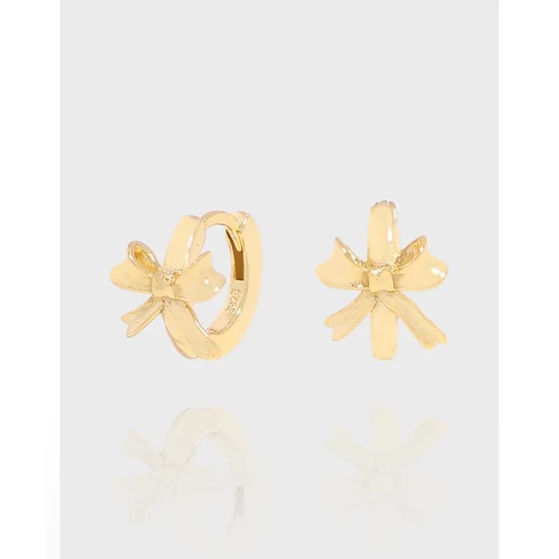 Pair of polished sterling silver earrings with a sculpted flower petal motif, one hoop and one stud.