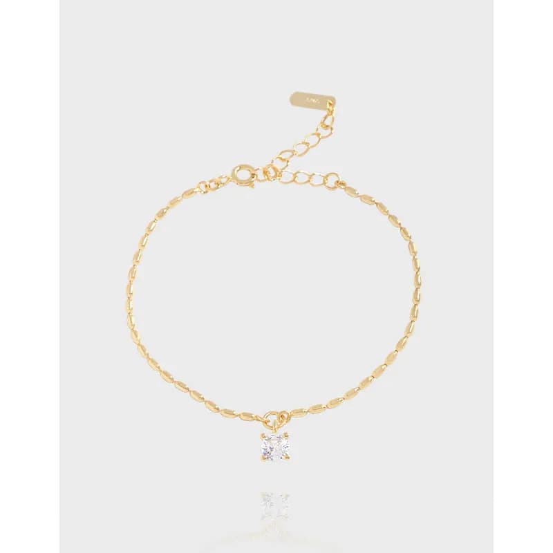 Delicate polished sterling-silver bracelet with a square-cut gem pendant on a light background.