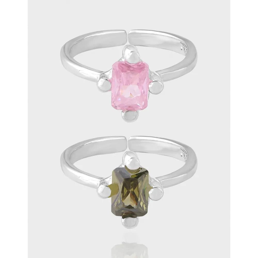 Polished sterling silver ring with a rectangular gemstone and bead accents on the band.