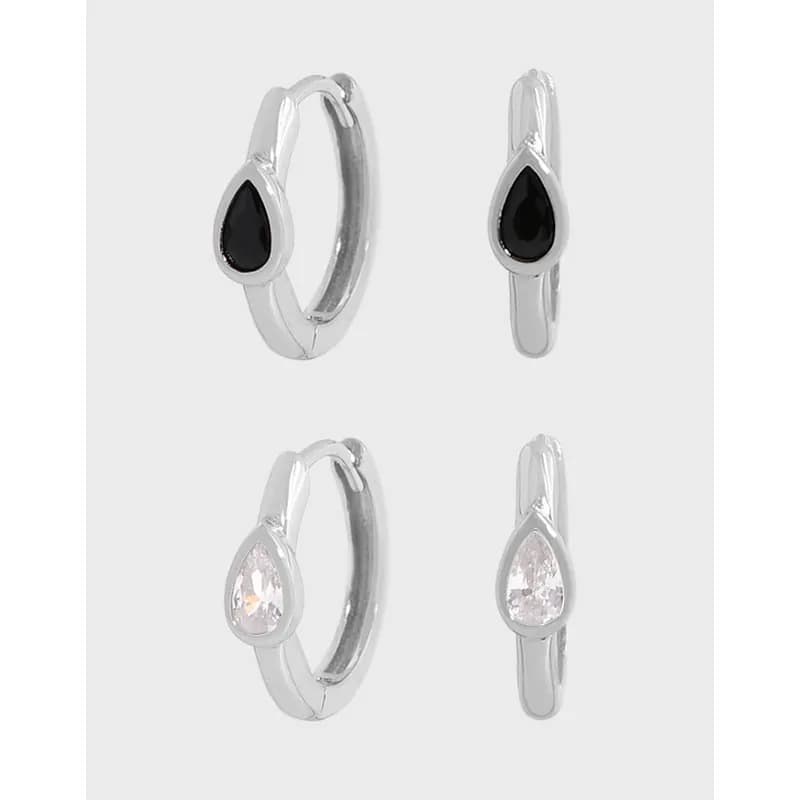 Polished sterling silver teardrop bezel hoop earrings with a small teardrop stone at the front.